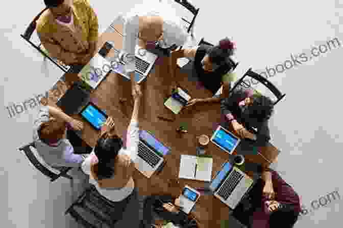 A Group Of People Working Together At A Table, Symbolizing Team Collaboration The Power Of Polarities: An Innovative Method To Transform Individuals Teams And Organizations Based On Carl Jung S Theory Of The Personality