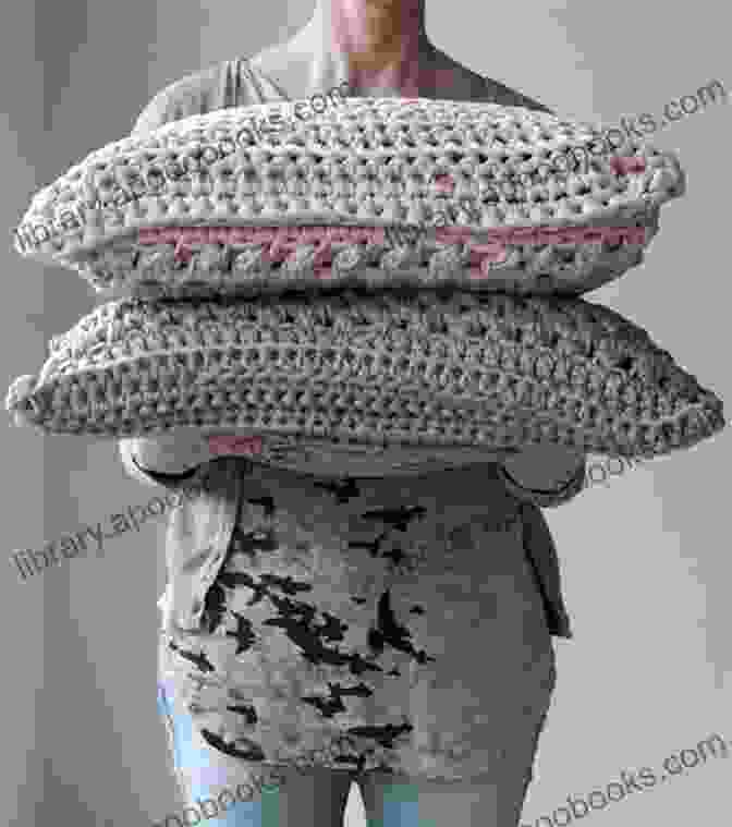 A Person Sitting On A Couch, Surrounded By Soft, Crocheted Pillows That Create A Relaxing Ambiance Crochet World 29 Projects To Make The Perfect Relaxing Retreat