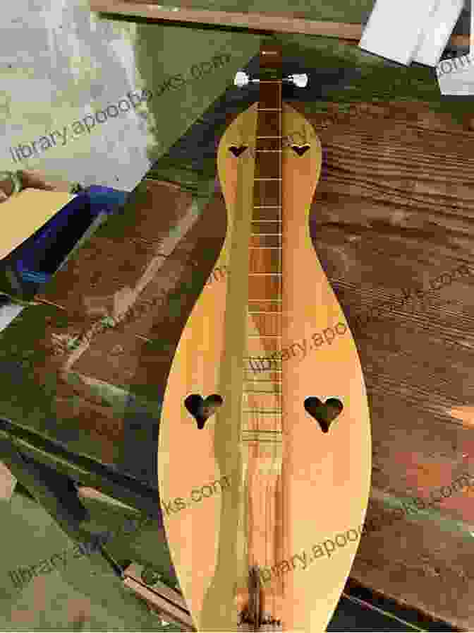 An Appalachian Dulcimer Resting On A Wooden Surface, With Intricate Carvings And Strings English Songs And Ballads For Appalachian Dulcimer